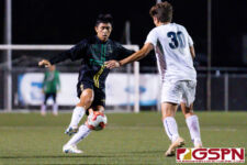 JFK Islander Christian Kido makes an attempt to get through Harvest Eagle defender Taka Ward. (Photo by Michael Blas)