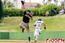JFK Islander first baseman Vince Camacho stretches high to out ND Royal Kobe Martinez. (Photo by Michael Blas)