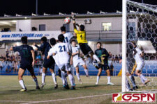 Harvest Eagle Goalkeeper Marcus Del Rosario makes a critical save on a JFK cross in extra time. (Photo by Michael Blas)