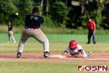 ND Royal Dominic Cruz slides back to first base before JFK Islander Vince Camacho can get to him. (Photo by Michael Blas)