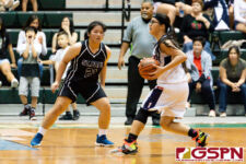 St. Paul Warrior Kat Santos maintains the pressure on defense while Okkodo Bulldog Angeli Dacanay looks for an opening. (Photo by Michael Blas)