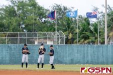 New Zealand's outfielders prepare themselves during a change of pitchers. (Photo by Michael Blas)