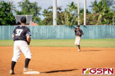 New Zealand's Hunter Sonthey launches the ball to Rodney Komene for an out at first base. (Photo by Michael Blas)