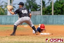 Guam's Zavier Camacho slides safely back to first base. (Photo by Michael Blas)