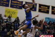 Warrior Josiah Quintanilla gets up to try and catch a high pass in the second half. (photo by Robert Balajadia)