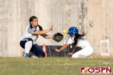 Academy Cougar Olivia Salas reaches for the ball as a Southern Dolphins player dives for third base. (Photo by Michael Blas)