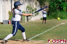 Academy Cougar Branwen Saville hits a grounder in the second inning. (Photo by Michael Blas)