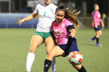 Heavy Hitters/Nutrition Mission Heat's Michala Connelley attempts to gain possession of the ball from University of Guam Lady Tritons' Colleen Naden during a Week 9 match of the Bud Light Women's Soccer League Premier Division Sunday at the Guam Football Association National Training Center. The Heat won 5-0. Photo by Andee Tydingco / GFA.