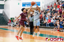 St. Paul Warrior Thelo Orichiro fires for three against FD Friar Colin Santiago. (Photo by Michael Blas)