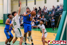 St. Paul Warrior Thelo Orichiro gets through the JFK Islander defense for a shot at the basket. (Photo by Michael Blas)