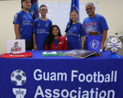 The Roberto family and friends pose for a photo after Shyann Roberto, seated in red jacket, signed an official commitment letter to play for Saint Martin's University's women's soccer team during a three-part signing event Saturday at the Guam Football Association National Training Center Lecture Hall. In the photo from left to right are, Johnny Cruz, Lacen Roberto, Shyann Roberto, Annette Roberto, and Joe Roberto.