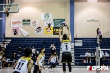 Titan High Titans T. Buekis sets up the spike for teammate X. Duenas. Photo by Bout It Productions