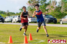 St. John's Knight Alex Clark and FD Friar Erwin Manibusan reaches the turn point first in the race. (Photo by Michael Blas)