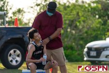 A Father Duenas Friar fan assists a runner after the race. (Photo by Michael Blas)