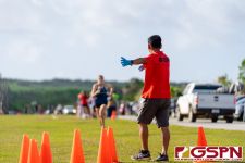 Jay Antonio, Official, guides runners to the finish line. (Photo by Michael Blas)