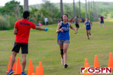 An Academy Cougar runner makes her way to the finish line of the IIAAG Cross Country All Island meet. (Photo by Michael Blas)