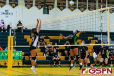 JFK Islander Kamalynne Lizama loads up for a spike against single blocker Heather Reyes. (Photo by Michael Blas)