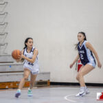 Academy Cougar Annika Almario dribbles past St, Paul Warrior Jan Quintanilla. ( photo by Bout It Productions )