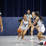 Academy Cougar Torie Rapadas dribbles the ball down court against the St. Paul Warriors. ( photo by Bout It Productions )