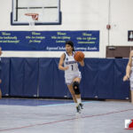 Academy Cougar Mia Taitano dribbles down court against the St. Paul Warriors. ( photo by Bout It Productions )