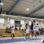 St. Paul Warrior Caressa Eter shoots over The Academy Cougar defenders. ( photo by Bout It Productions )