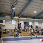 St. Paul Warrior La Hernandez takes it to the rim against the Academy Cougars. ( photo by Bout It Productions )