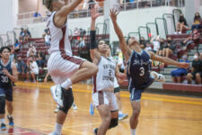 St. Paul Warrior guard Jon Sevilla fights through contact on his way to the basket. (photo by Raine Delos Reyes)