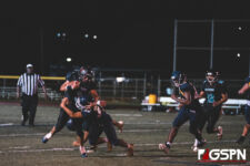 Southern High Dolphin Isaiah Topasna gets wrapped by Guam High Panther Terrell Rosario. (photo by Bout It Productions)