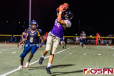 GW Gecko Noah Castro leaps up to make the catch against GHS Panther Benjamin Harris. (Photo by Michael Blas)