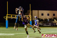 GHS Panther Benjamin Harris completes the catch against GW Gecko Kuuipomaikalani Indalecio. (Photo by Michael Blas)