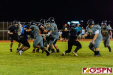 JFK Islander Trey Blas calls an audible and sneaks up the middle for a big gain. (Photo by Michael Blas)