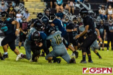 JFK Islanders Austin Santos and Gage Chinel make a tackle against SHS Dolphin Isaiah Topasna. (Photo by Michael Blas)