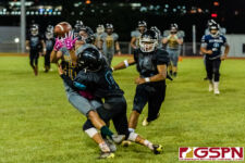 SHS Dolphin Jaren Leon Guerrero breaks up a pass for JFK Islander Irvin White. (Photo by Michael Blas)