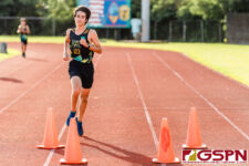 JFK Islander Hugh Kent kicks towards the finish line for a first place finish. (Photo by Michael Blas)
