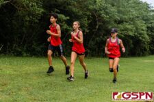 A small pack of St. John's Knights work their way through the midway point of the race. (Photo by Michael Blas)