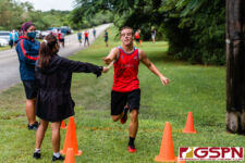 St. John's Knights Bubba Sullivan reaches for his placement at the finish line. (Photo by Michael Blas)