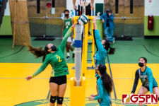 JFK Islander Philicita Rivera tips the ball against SHS Dolphin Ariana Flores. (Photo by Michael Blas)