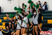 The JFK Islander JV squad cheer on their Varsity team after taking the second set. (Photo by Michael Blas)