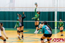 JFK Islander Maya Andres leaps up for a spike against SHS Dolphin Railyn San Agustin. (Photo by Michael Blas)