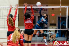 AOLG Cougar Hinengi San Nicolas sends the ball through the SJS Knight blockers. (Photo by Michael Blas)
