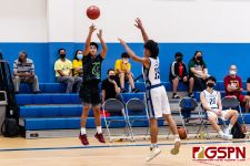 JFK Islander Vorel Cruz fires from long range against HCA Eagle Calvin Laxamana. (Photo by Michael Blas)