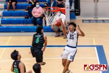 JFK Islander Justin Lizama stuffs HCA Eagle Calvin Laxamana under the net. (Photo by Michael Blas)
