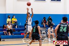 HCA Eagle Calvin Laxamana sinks the ball in for three. (Photo by Michael Blas)