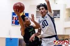 JFK Islander Vorel Cruz goes in for a lay up against HCA Eagle Alex Oralles. (Photo by Michael Blas)
