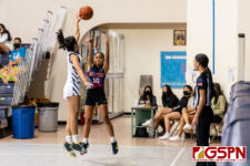 OHS Bulldog Ariel Anderson fires for three as AOLG Cougar Mia Taitano gets a touch on the ball. (Photo by Michael Blas)