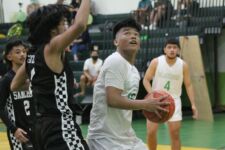 JFK Islander Karl Vinca gets the inside position on Shark Geoff Gozum for two points. (photo by Robert Balajadia)