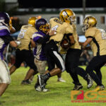 George Washington Geckos Jon Espino breaks through the line of scrimmage for a sack on Tiyan Titans John Angoco. (Photo by Michael Blas)