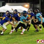 Southern Dolphin RB Conan Baza runs through the Gecko defensive line for a first down. (Photo by Michael Blas)