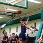 JFK Islanders Jerry Ngiraremiang gets the ball up as Okkodo Bulldogs Rylen Cajigal reaches for a block. (Photo by Michael Blas)