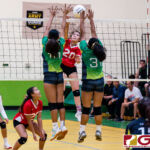 St. John's Knight Hallie Wigsten spikes through Islander blockers Kiana Rivera and Valerie Escalona. (Photo by Michael Blas)